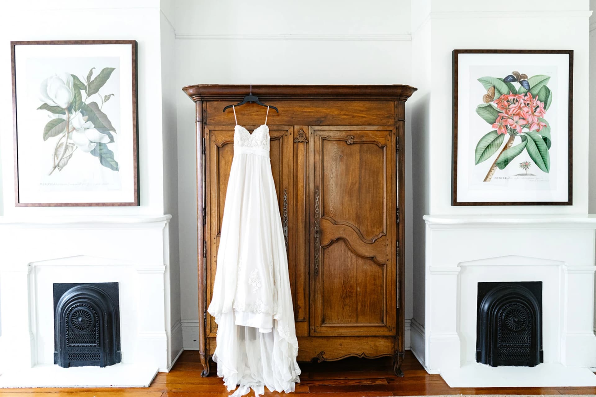 A wedding dress hanging from the antique armoire at The Mazant