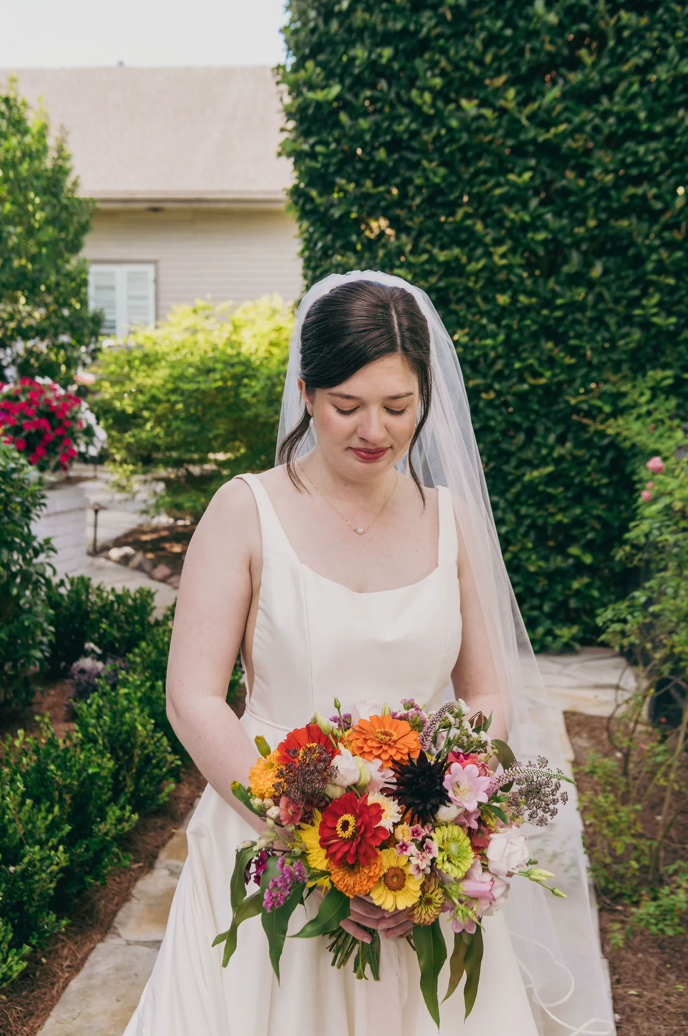 Bride holding flowers in the garden at The Mazant